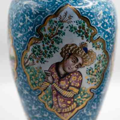 Vase with woman: The vase features vibrant blue enamel decorated with intricate people and bird designs.