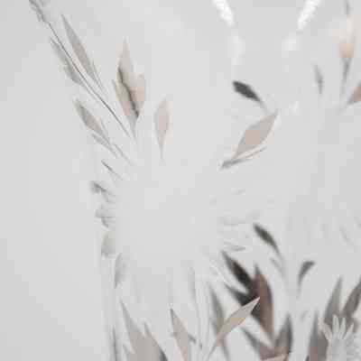 Detail of the crystal vase given to Mrs. Jessie Jordan by Mr. L.T. Jordan for their 25th wedding anniversary.: Up close image of the etched flower and silver leaf design on the crystal vase.