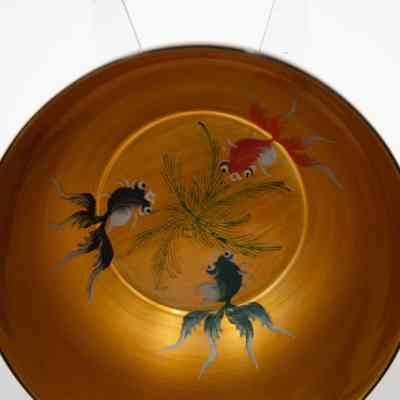 Inside of one of the soup bowls.: Up close image of the inside of one of the 12 soup bowls painted with colorful goldfish.