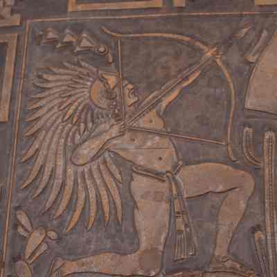 Archer on leather mat: The tooled leather desk mat depicts an archer with an Aztec headdress aiming a bow.
