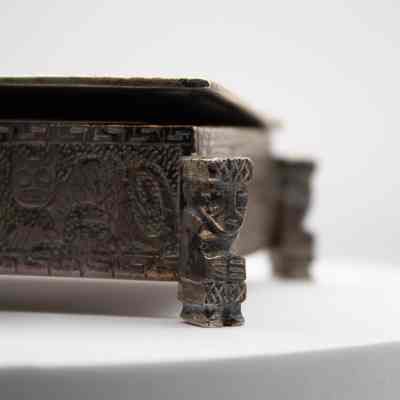 Cigarette box: The Peruvian chased silver box features intricate Incan-style mythological engravings and ornate corner details.