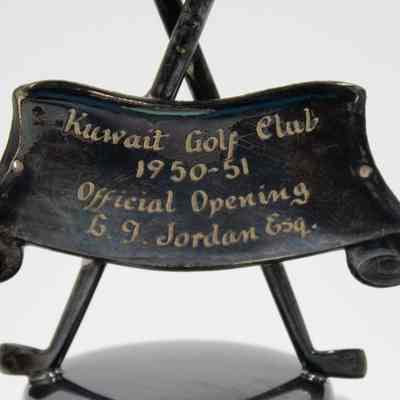 Scroll on Trophy: The trophy has a large black, metal scroll with "Kuwait Golf Club; 1950-1951; Official Opening; L.T. Jordan Esq."