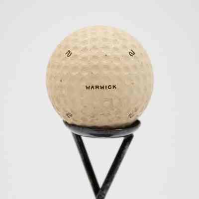 Golf ball on trophy: The golf ball is branded with "Warwick."
