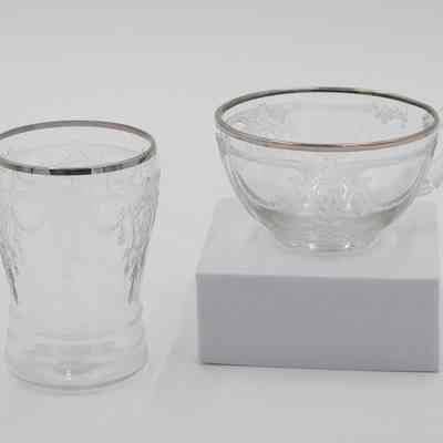 Juice glass and tea cup: The image shows a clear "ballerina" cameo glass set with platinum trim details.