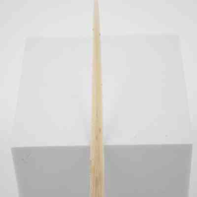 Swordfish blade letter opener with sterling silver handle.: Up close image of the letter opener propped up against a white block. The blade is a swordfish and is double-edged. The handle is sterling silver with slight tarnish.