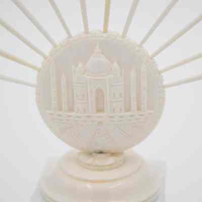 Base of one of the skewer sets.: Up close image of the base of one of the ivory bases. It depicts the Taj Mahal.