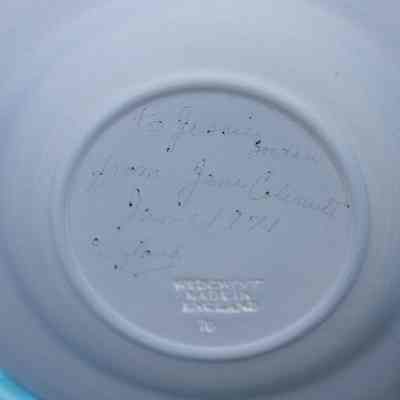 Bottom of blue Wedgwood dish: The bottom of the pale blue dish has "to Jessie Jordan from Jane Colemutt Jan. 1971 England" written in pencil with "WEDGWOOD ENGLAND" carved into it.