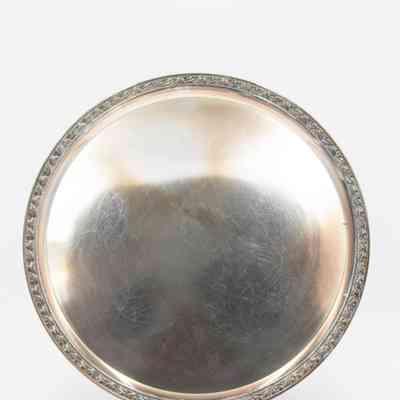 Tray: Image of a circular silver tray on a plastic stand. There are small scratches on the surface of the tray.