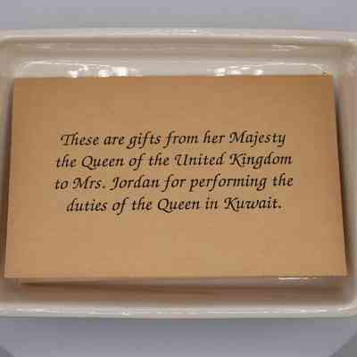 Note inside box: An offwhite paper, "These are gifts from her Majesty the Queen of the United Kingdom to Mrs. Jordan for performing the duties of the queen in Kuwait."