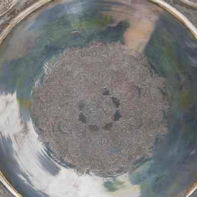 Silver plate: The silver plate features an intricate etched mandala design, displayed elegantly on a stand.
