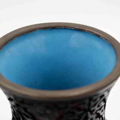 Blue interior: The image shows the top view of a vase, revealing its vibrant blue interior.