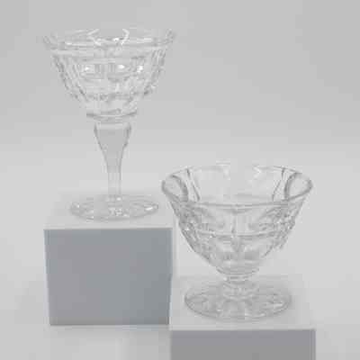 Fruit cup and sherbet dish: The image shows two crystal dishes, one a fruit cup and the other a sherbet dish. The fruit cup has no stem, and the sherbet dish has a long stem.