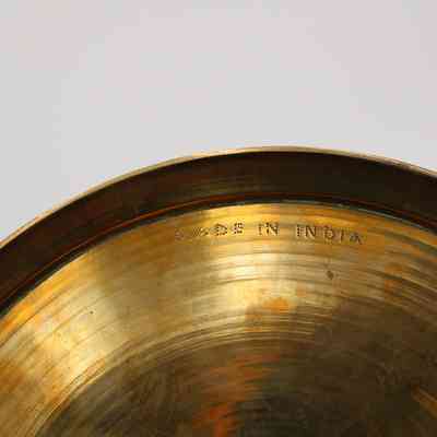 Stamp on bottom of bowl: The brass bottom has a dotted, "Made in India."