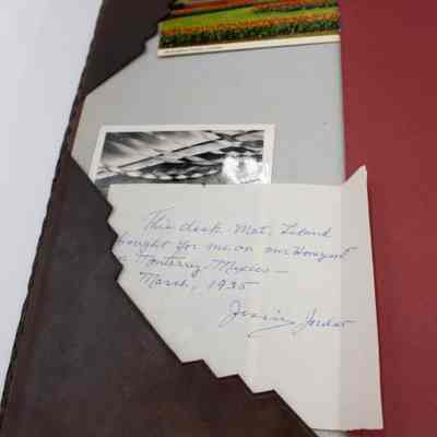 Items inside desk mat: A handwritten note from Jessie Jordan, "This desk mat, Leland bought for me on our Honeymoon in Monterey, Mexico- March 1935. Jessie Jordan."