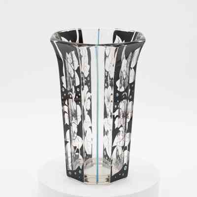 Handblown glass vase with flower and leaf design.: Image of handblown glass vase with black flowers and leaves and blue dots. There is a blue line running down four of the sides.