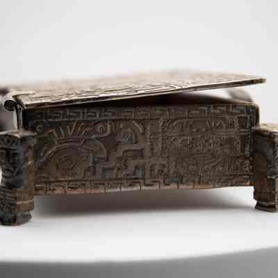Cigarette box: The Peruvian silver cigarette box features intricate Incan-style mythological art and decorative motifs.