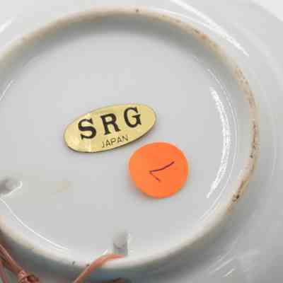 Bottom of ashtray: The underside of a ceramic map ashtray reads "SRG Japan" with orange sticker.
