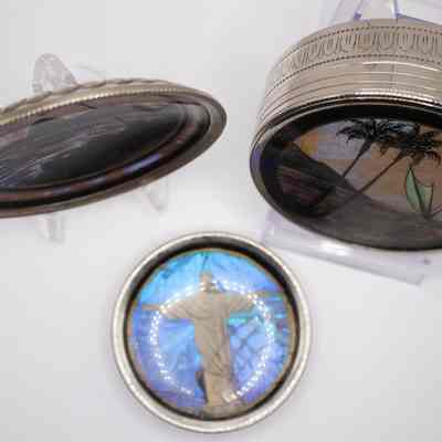 Full set of coasters: A top-down image taken to display the other coaster. This coaster depicts the "Christ the Redeemer" statute from Rio de Janeiro, Brazil. Behind the depiction of the statue is a combination of blues and purples painted onto the coaster.