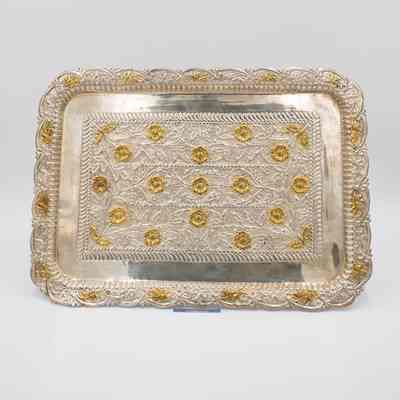 Yellow gold rose tray given to Mrs. Jessie Jordan by Mrs. Al-Ghanim.: Image of the debossed silver tray with yellow gold rose details propped up.