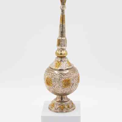 Rose water sprinkler given to Mrs. Jessie Jordan by Mrs. Al-Ghanim.: Image of the engraved silver rose water sprinkler decorated with yellow gold roses.