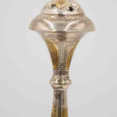 Lid of rose water sprinkler given to Mrs. Jessie Jordan by Mrs. Al-Ghanim.: Up close image of the lid of the engraved silver rose water sprinkler decorated with yellow gold roses and leaves.