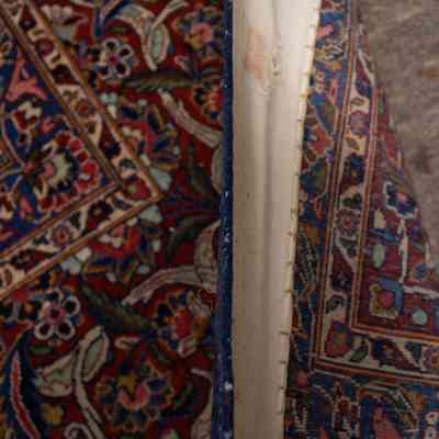 Red and blue area rug: The rug features intricate floral patterns in red, blue, and teal with detailed artistry.