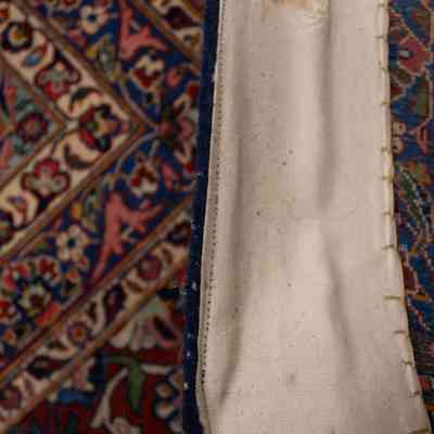 Red and blue area rug: The image shows a detailed view of a patterned red and blue rug.