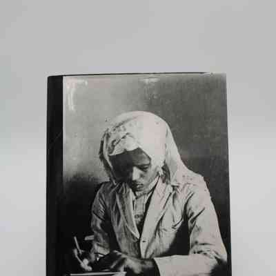 Back Cover of "Kuwait of the Past": The back cover of "Kuwait of the Past" has an image of a Kuwaiti man writing.