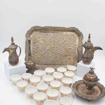 Coffee service gifted to the Jordans by Sheikh Ahmad Al-Jaber Al-Sabah.: Image of the 28-piece porcelain, silver, and gold coffee service. It contains one large silver coffee pot, one small silver coffee pot, one large rectangular silver tray, one small round footed tray with a silver incense burner, one tall rosewater sprinkler, and twenty-three bone China and gold coffee cups.