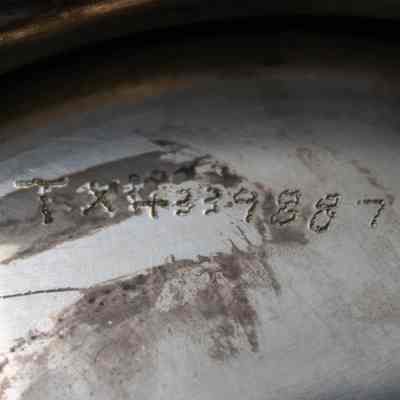 Inventory number engraved into the bottom of the silver trophy cup given to Mrs. Jessie Jordan.: Up close image of the engraved inventory number likely done by the Jordans. It reads "TX4339887."