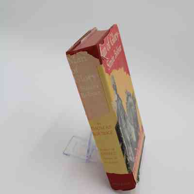 Book Spine of “Man of Glory - Simon Bolivar”: The spine of “Man of Glory - Simon Bolivar” features the title and author's full name. The hardback cover is worn and torn in some areas, revealing the red hardcover underneath.