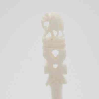 The end of one of the skewers.: Up close image of the end of one of the skewers. It depicts an elephant.