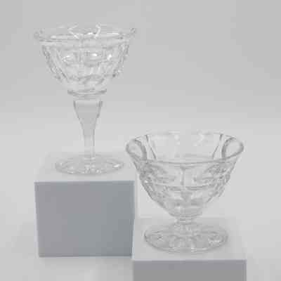 Fruit cup and sherbet dish: The image shows two crystal dishes, one a fruit cup and the other a sherbet dish. The fruit cup has no stem, and the sherbet dish has a long stem.