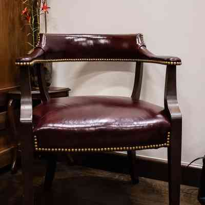 Pair of Panel Backed Burgundy Leather Studded Chairs