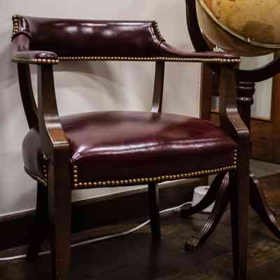 Leather studded chairs: A burgundy leather chair with studded detailing.