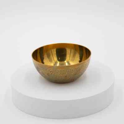 Blue designed bowls: A brass bowl with blue floral designs.
