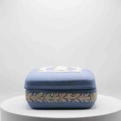 Side of blue Wedgwood Jasperware square box: The rounded boxes side, trimmed with white leaves.