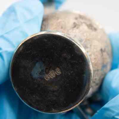 Bottom of Persian silver sugar bowl.: Up close image of the bottom of the Persian silver sugar bowl. It is stamped with three maker's marks in Arabic.