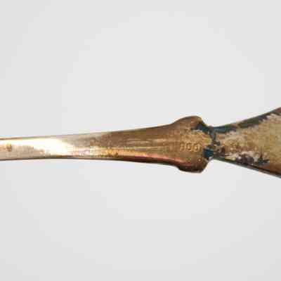 Back of the handle of one of the Kuwaiti coffee spoons.: Up close image of the back of the handle of one of the silver coffee spoons. It is stamped with "800."