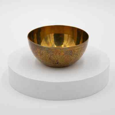 Peacock bowl: The brass bowl features intricate peacock designs.