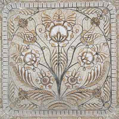 Square silver lace filigree tray. Pattern is floral with seven large blossoms in the center.: Up close image of the center of the tray, there is a seven-blossom flower. There are lots of small swirls in the pattern.