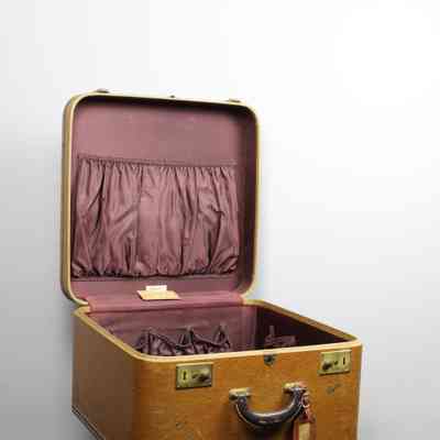 L.T. Jordan open suitcase: The L.T. Jordan suitcase is open, revealing a maroon interior with pockets.