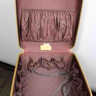 L.T. Jordan open suitcase: The L.T. Jordan suitcase is open, revealing a maroon interior with pockets and straps.