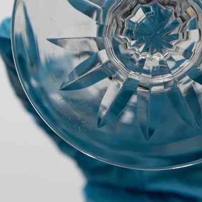 Engraving on bottom of sherbet dish: The image shows an engraving on the bottom of the fruit cup, illegible.