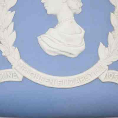 Close up of banner on blue Wedgwood Jasperware square box: Close up of the banner where it has raised writing stating "H.M. QUEEN ELIZABETH II JUNE 1953."