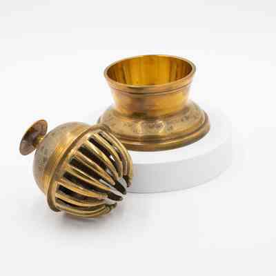 Meditation bell: The image features brass meditation bells with intricate leaf designs.