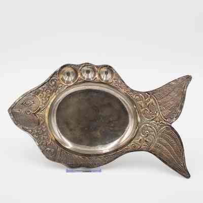 One silver fish platter: The image shows an ornate silver platter shaped like a fish, featuring intricate detailing and decorative engravings throughout its design.