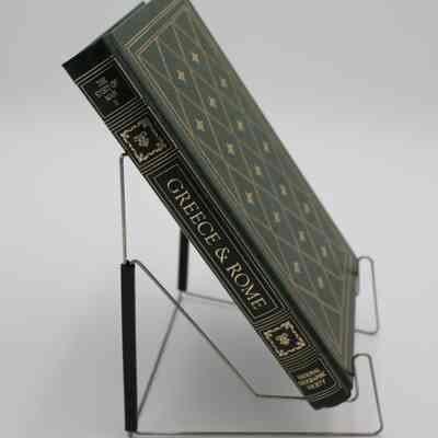 Book Spine: The spine of “Greece and Rome” is portioned off into 5 sections. The first section has the subtitle "The Story of Man II", the second and fourth sections contain regal ornaments, the third is the title, and the fifth is for the creator, National Geographic Society. All of the details are colored gold.