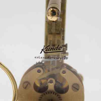 Logo on back: "Kundo Electronics," visible over internal clock mechanisms.
