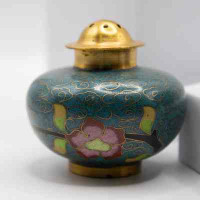Teal shaker: Teal salt shaker with a pink flower design.